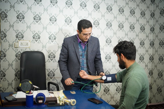 Médico tomando la tensión